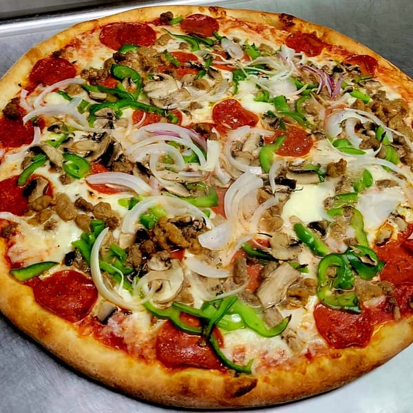 A Cedar's Pizza with pepperoni, sausage, mushrooms, green peppers, and onions.